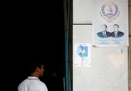 A man walks near posters the Cambodia National Rescue Party (CNRP) and Cambodian People's Party (CPP), in Phnom Penh, Cambodia, November 20, 2017. REUTERS/Samrang Pring
