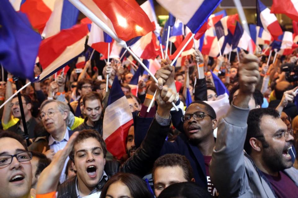 Head-tohead: Supporters of French centrist presidential candidate Emmanuel Macron react to the news (AP)