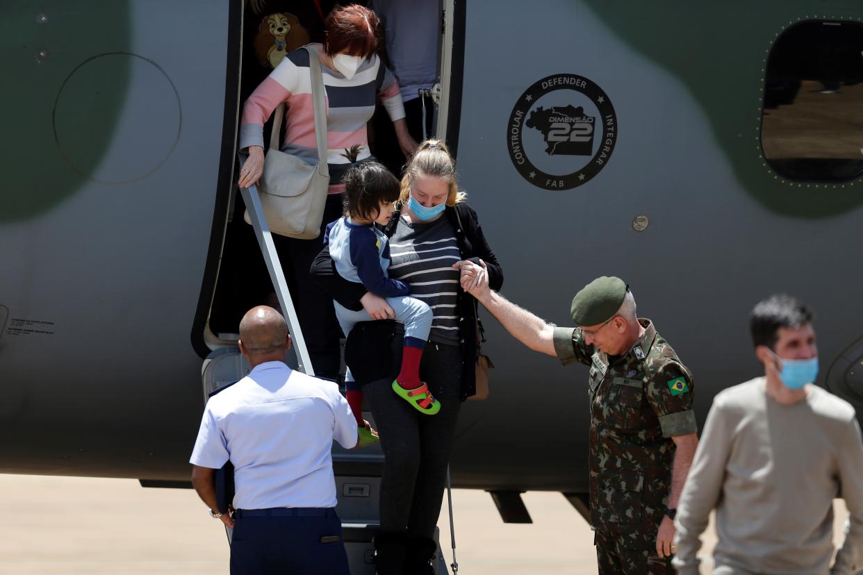 People evacuated from Ukraine land at Brasilia Air Base, Brazil, on March 10, 2022. (Photo by Lucio Tavora/Xinhua via Getty Images)
