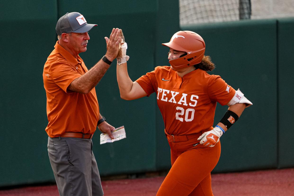 Texas freshman Katie Stewart high-fives head coach Mike White after a home run during the Longhorns' 5-2 win over Iowa State at McCombs Field on Friday. With the win, Texas remained a game back of Oklahoma in the Big 12 standings.