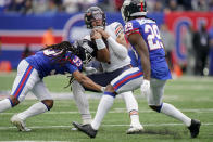 New York Giants cornerback Aaron Robinson (33) sacks Chicago Bears quarterback Justin Fields (1) during the second quarter of an NFL football game, Sunday, Oct. 2, 2022, in East Rutherford, N.J. (AP Photo/John Minchillo)