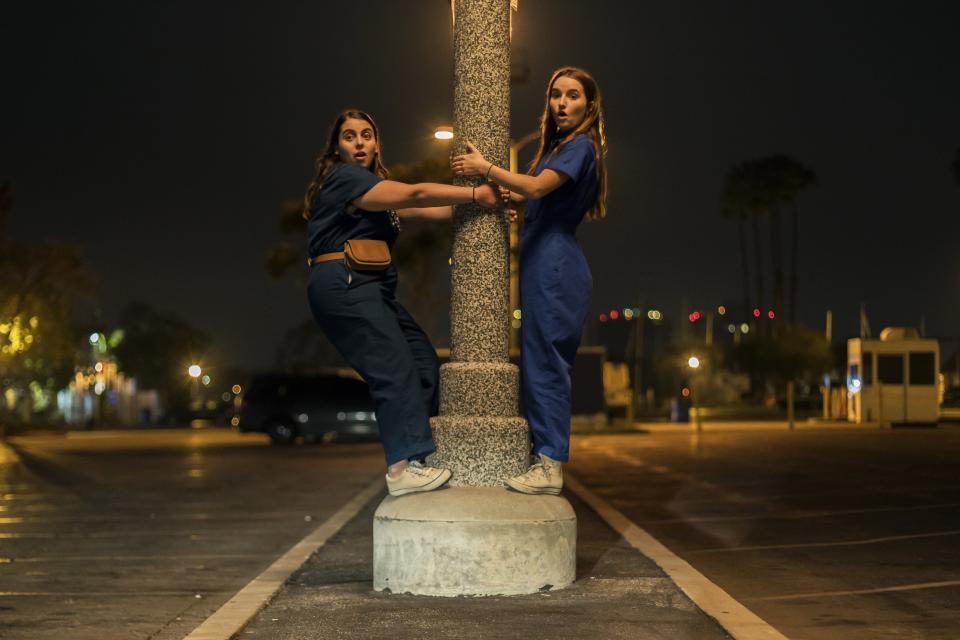 Molly (Feldstein) and Amy (Dever) in their blue jumpsuits