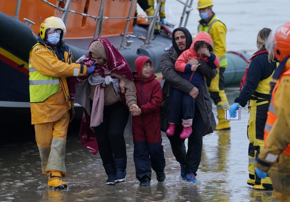 Migrants are helped ashore in Kent (Gareth Fuller/PA) (PA Wire)