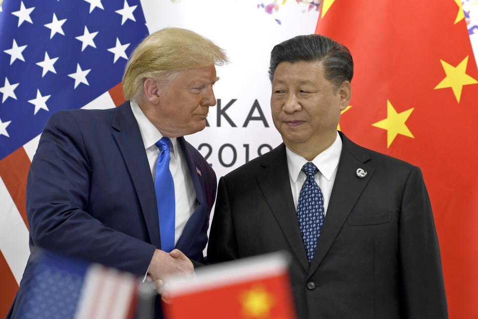 FILE - In this June 29, 2019, file photo, U.S. President Donald Trump, left, shakes hands with Chinese President Xi Jinping during a meeting on the sidelines of the G-20 summit in Osaka, western Japan. Facing another U.S. tariff hike, Xi is getting tougher with Washington instead of backing down. Both sides have incentives to settle a trade war that is battering exporters on either side of the Pacific and threatening to tip the global economy into recession. (AP Photo/Susan Walsh, File)