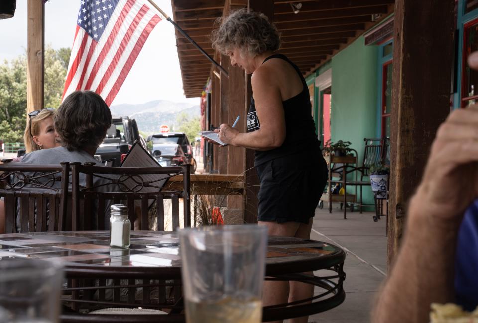 Patagonia Mayor Andrea Wood (center) waits on customers at the Gathering Grounds in Patagonia on June 18, 2023.