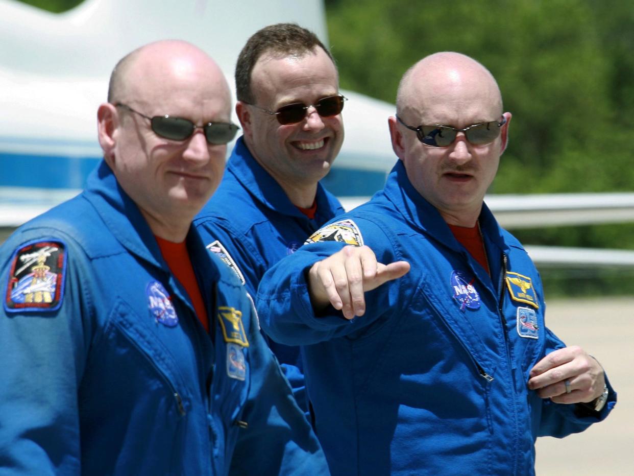 Shuttle Discovery commander Mark Kelly, right, gestures as he walks with his twin brother, astronaut Scott Kelly: AP