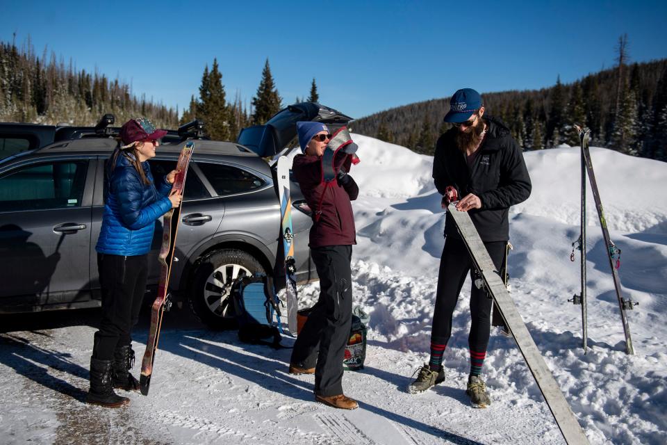 Nora Flynn, Molly McLaughlin, and Zach Taylor, all from Fort Collins, prepare for a day of skiing near the Zimmerman Lake Trailhead off Cameron Pass on Jan. 15.