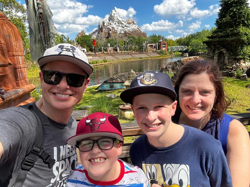 kari and her family posing with expedition everest in the background at animal kingdom