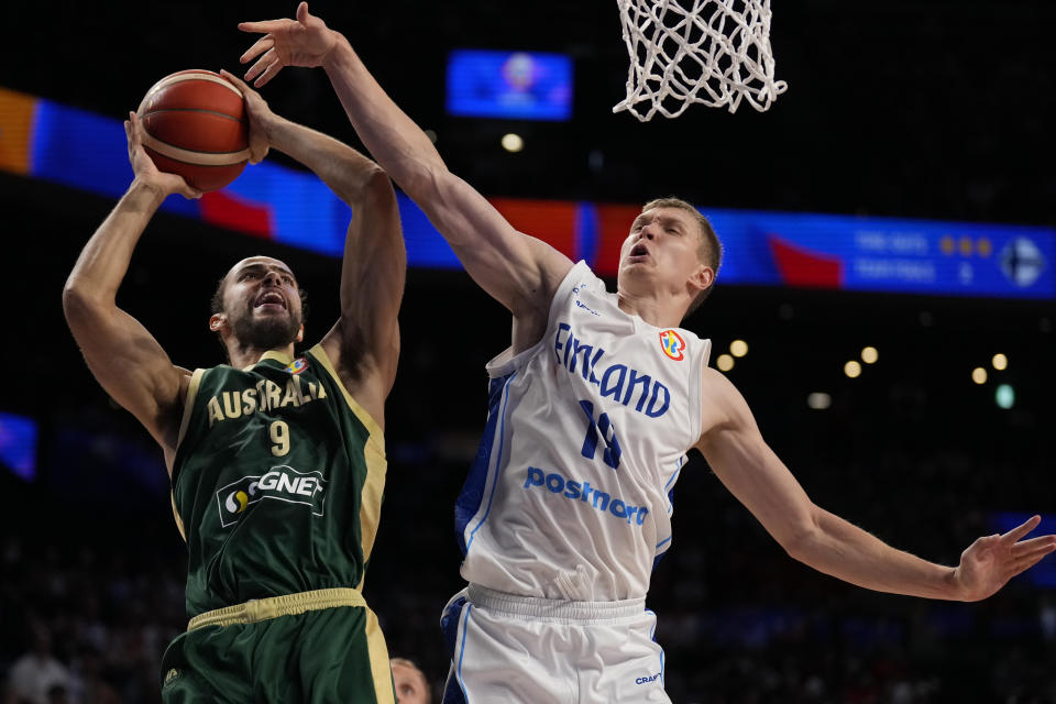 Australia forward Xavier Cooks (9) goes up for a shot against Finland forward Elias Valtonen (19) during the second half of the Basketball World Cup group E match between Finland and Australia in Okinawa, southern Japan, Friday, Aug. 25, 2023. (AP Photo/Hiro Komae)