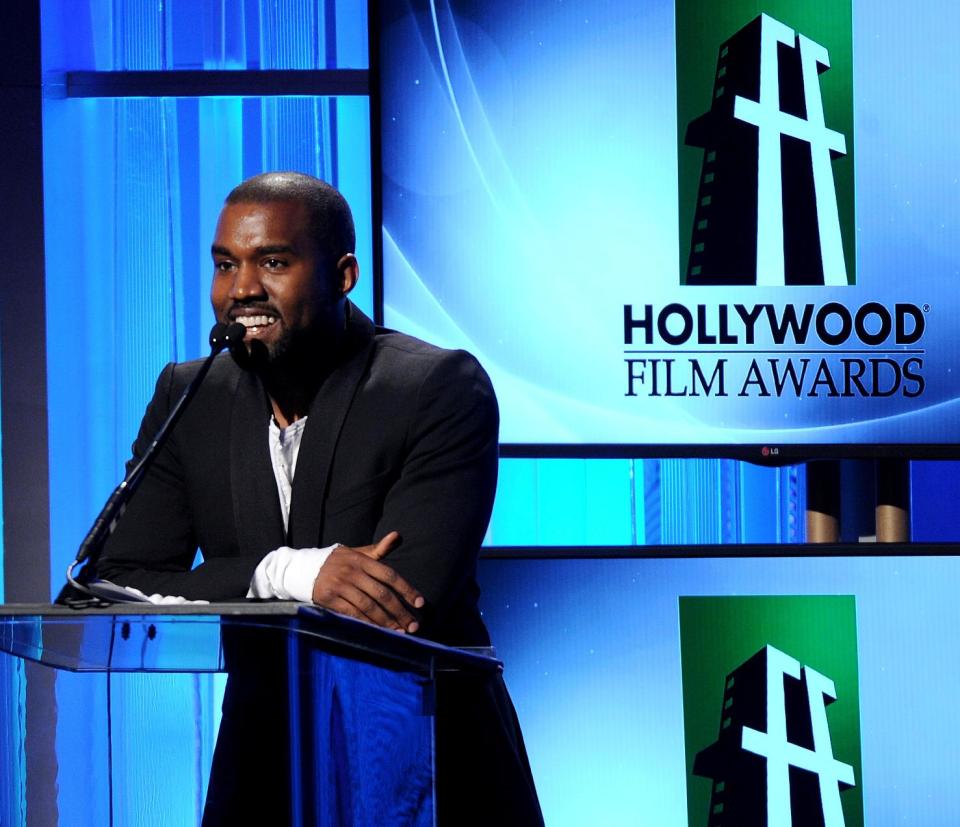 FILE - In this Tuesday, Oct. 22, 2013 file photo, recording artist Kanye West speaks onstage during the 17th Annual Hollywood Film Awards Gala at the Beverly Hilton Hotel in Beverly Hills, Calif. Los Angeles County prosecutors declined to file charges against West on Friday, Jan. 31, 2014, after the man the rapper allegedly punched in a Beverly Hills chiropractor's office declined to cooperate with the case. (Photo by Frank Micelotta/Invision/AP, File)