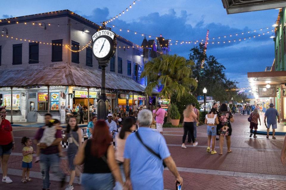 Patrons walk around Old Town, a throwback entertainment and retail center in Kissimmee, Fla.