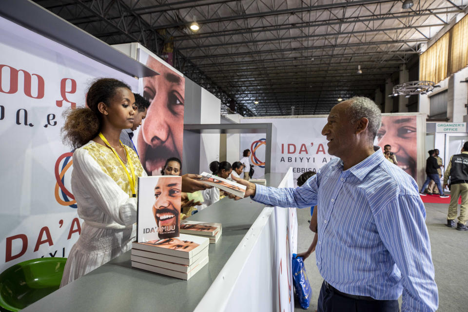 A customer purchase Prime Minister Dr Abiy Ahmed's book on MEDEMER (synergy) after it was launched Saturday Oct. 19, 2019, at the Ethiopian capital Addis Ababa. Ethiopia's Nobel Peace Prize-winning prime minister's book of his ideology, with one million copies already printed. Saturday's launch again raises concerns among some in the East African nation that a cult of personality could spring up around Prime Minister Abiy Ahmed, who announced sweeping political reforms after taking office last year. (AP Photo/Mulugeta Ayene)