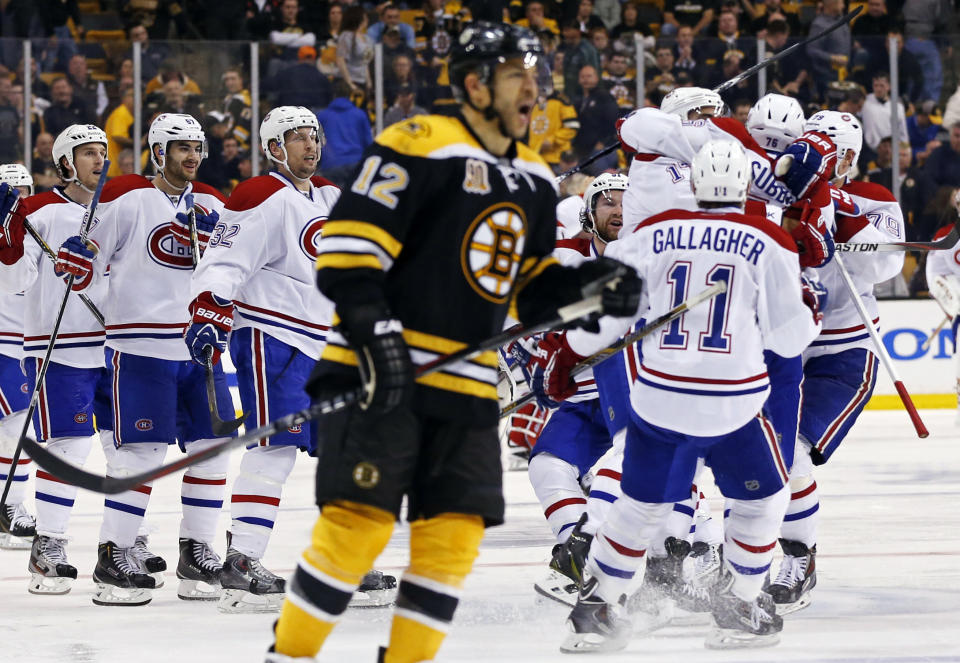 Montreal Canadiens teammates jump on P.K. Subban, right, after his game-winning goal in the second overtime period as Boston Bruins right wing Jarome Iginla (12) skates away in Game 1 of an NHL hockey second-round playoff series in Boston, Thursday, May 1, 2014. (AP Photo/Elise Amendola)