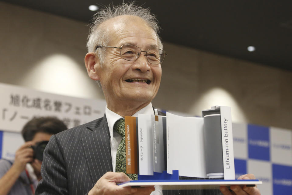 Winner of Nobel Prize in Chemistry Akira Yoshino poses a photo with a model of Lithium-ion battery during a press conference in Tokyo, Wednesday, Oct. 9, 2019. Yoshino is one of the three scientists who have won this year's Nobel Prize in Chemistry for their contributions to lithium-ion batteries, which have reshaped energy storage and transformed cars, mobile phones and many other devices in an increasingly portable and electronic world. (AP Photo/Koji Sasahara)