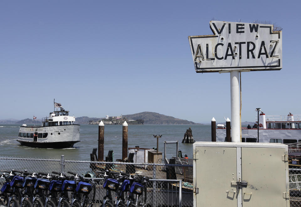 In this photo taken Thursday, May 24, 2012, a harbor cruise boat makes it way back to Fisherman's Wharf with Alcatraz Island in the background in San Francisco. (AP Photo/Eric Risberg)