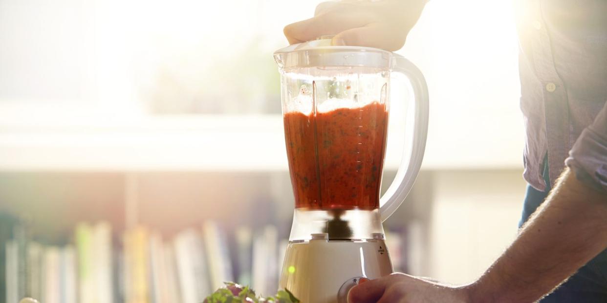 man making a smoothie at home