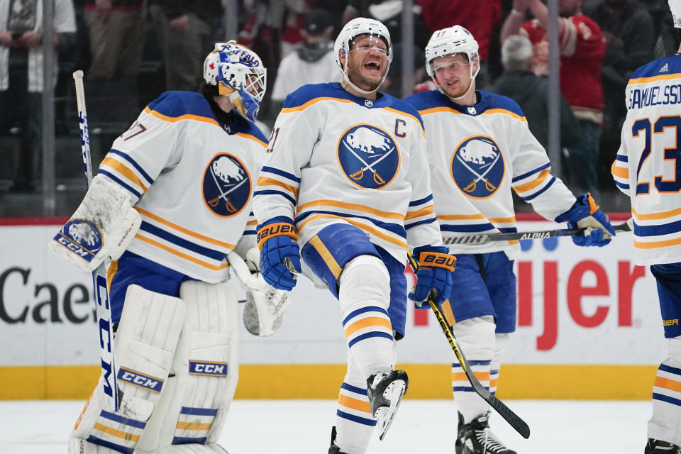 Buffalo Sabres right wing Kyle Okposo, center, celebrates after a shootout in an NHL hockey game against the Detroit Red Wings Thursday, April 6, 2023, in Detroit. Buffalo won 7-6. (AP Photo/Paul Sancya)