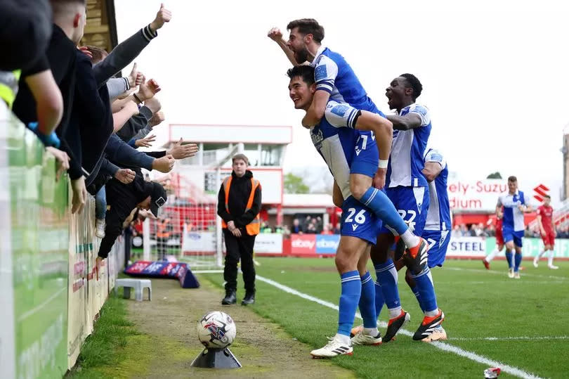 Bristol Rovers players celebrate their third goal at Cheltenham Town with the travelling Gasheads -Credit:Will Cooper/EFL