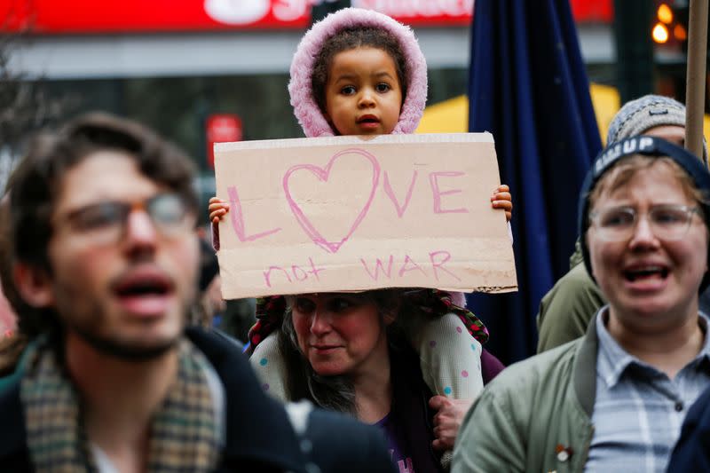 People march as they take part in an anti-war protest amid increased tensions between the United States and Iran at Times Square in New York