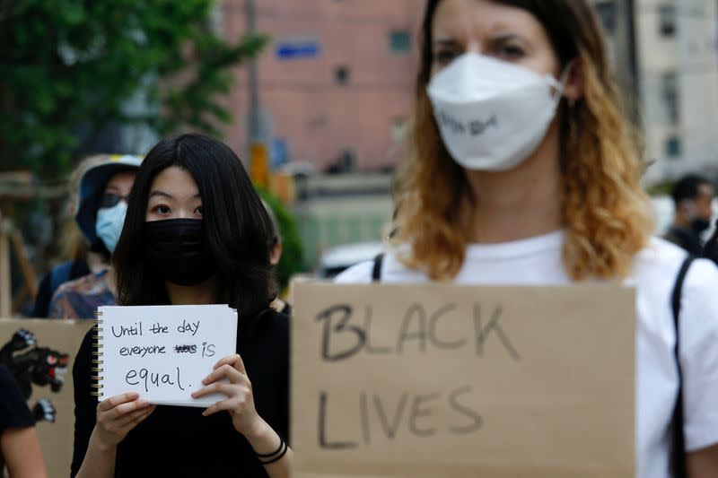 People march on the street in solidarity with protests against the death in Minneapolis police custody of George Floyd in Seoul