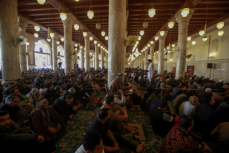 Supporters of the Shiite cleric Muqtada al-Sadr pray during Friday prayers at a mosque in Kufa, Iraq, Friday, Dec. 2, 2022. Al-Sadr who announced his withdrawal from politics four months ago has broken a period of relative silence to launch an anti-LGBTQ campaign. (AP Photo/Anmar Khalil)