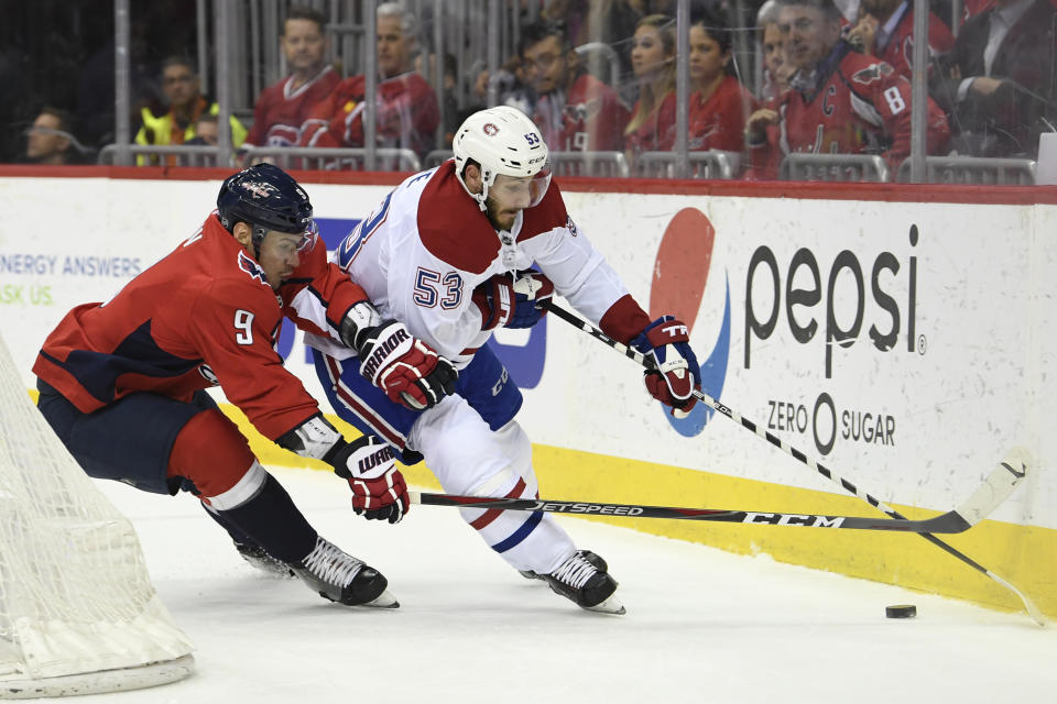 Washington Capitals defenseman Dmitry Orlov (9), of Russia, tries to take the puck from Montreal Canadiens defenseman Victor Mete (53) during the first period of their NHL hockey game in Washington, Thursday, April 4, 2019. (AP Photo/Susan Walsh)