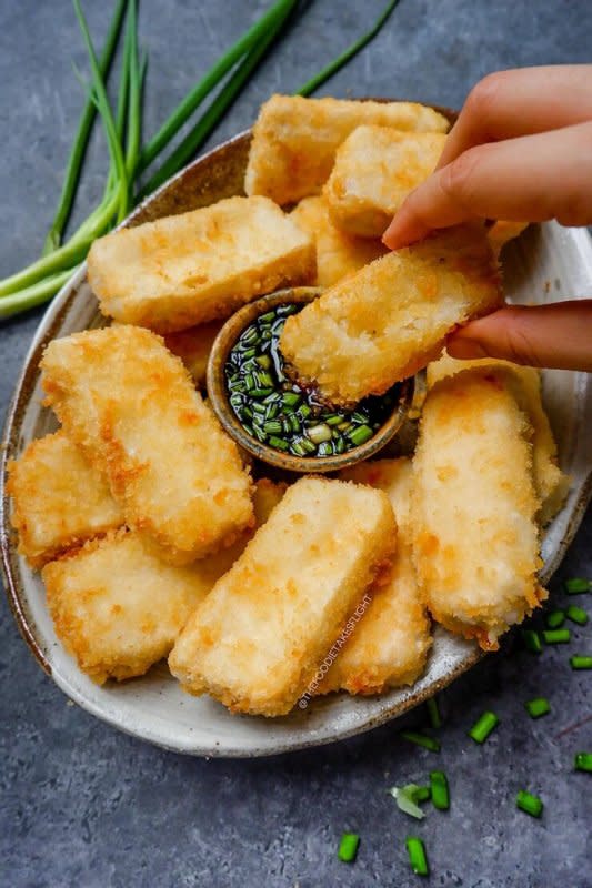 <p>The Foodie Takes Flight</p><p>Here’s some some crispy tofu with sweet scallion sauce! You can opt to fry or bake the tofu and enjoy them with sweet scallion sauce or your dip of choice.</p><p><strong>Get the recipe: <a href="https://thefoodietakesflight.com/baked-or-fried-crispy-tofu-with-sweet-scallion-sauce-vegan-recipe/" rel="nofollow noopener" target="_blank" data-ylk="slk:Crispy Tofu with Sweet Scallion Sauce;elm:context_link;itc:0;sec:content-canvas" class="link "><em>Crispy Tofu with Sweet Scallion Sauce</em></a></strong></p>