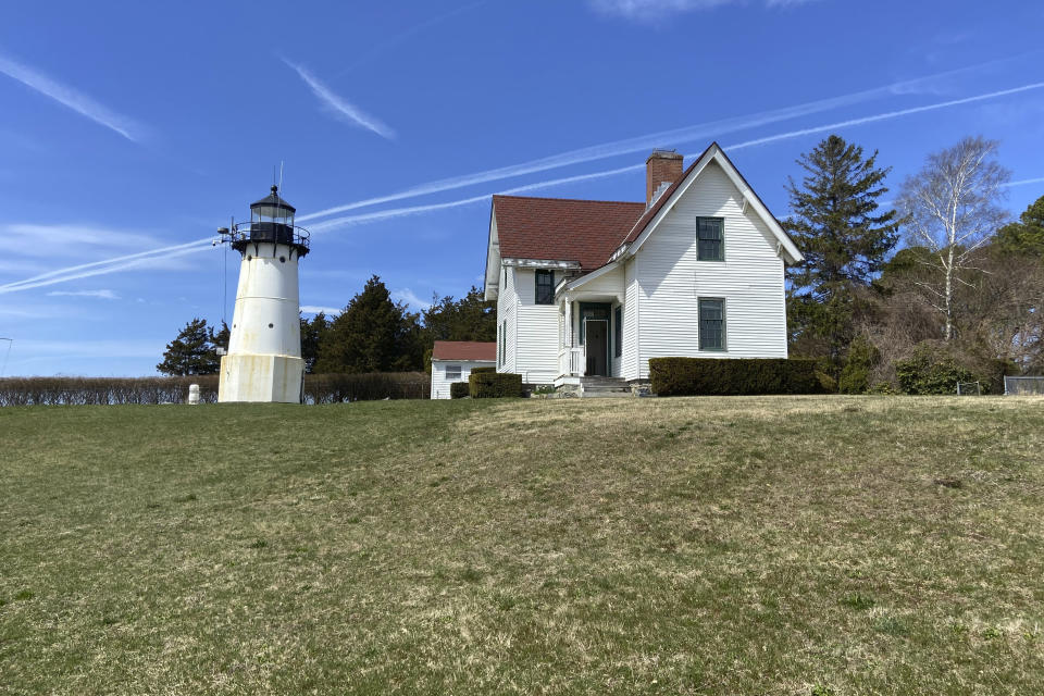 Warwick Neck Light, that dates to 1827 and was a onetime important navigation tool for mariners making their way to Providence, R.I., stands near Narragansett Bay, April 12, 2023, in Warwick, R.I. The federal government's annual effort to give away or sell lighthouses that are no longer needed for navigation purposes includes 10 lighthouses this year. (Barbara Salfity/General Services Administration via AP)
