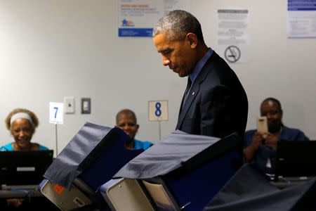 U.S. President Barack Obama casts his vote for president in early voting at the Cook County Office Building in Chicago, Illinois, U.S. October 7, 2016. REUTERS/Jonathan Ernst