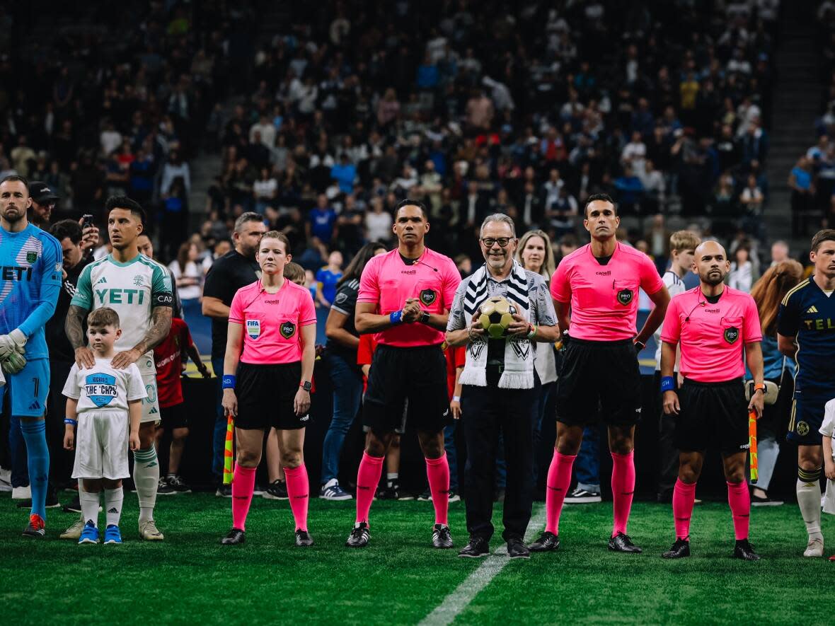 The first-ever Vancouver Whitecaps signing, Glen Johnson, is seen with the original ball from the team's May 5, 1974 debut in the North American Soccer League. The Whitecaps celebrated their 50th anniversary with a game against Austin FC on Saturday. (Bob Frid/Vancouver Whitecaps FC - image credit)