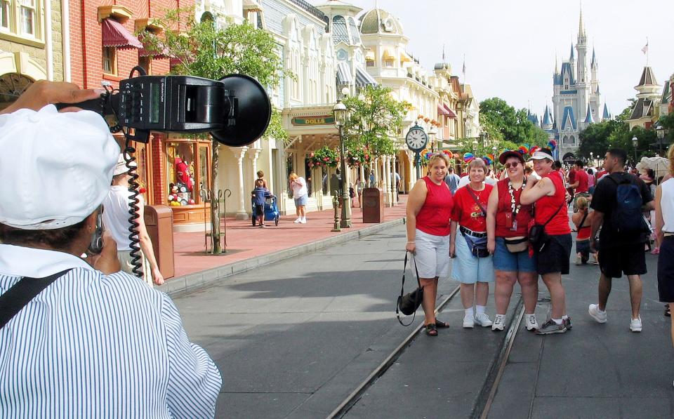 A group gets a souvenir picture taken in front of Cinderella's Castle at Disney World's Magic Kingdom during "Gay Days" weekend, 2003.