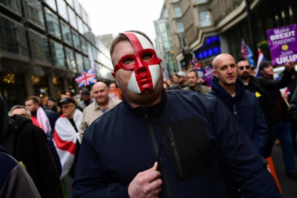 A protester at the Brexit Betrayal rally wearing a mask of the England flag (Getty Images)