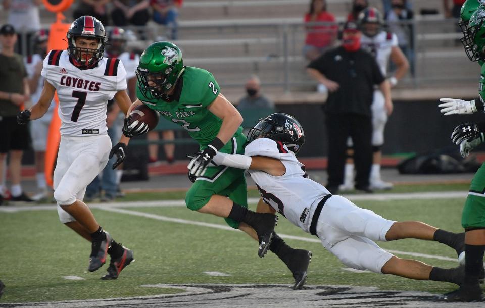 Wihcita Falls High's Guy Izaguarre (7) and Ayden Ramirez (27) ring down Iowa Park senior Cameron Parker (2) Friday night in Iowa Park.