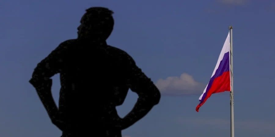 Silhouette of a man against the background of the Russian flag in Moscow