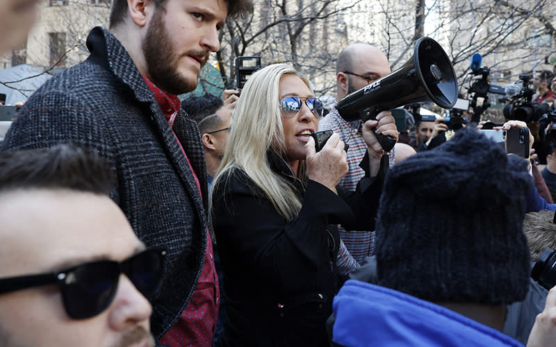 Rep. Marjorie Taylor Greene (R-Ga.) uses a megaphone to speak outside of the New York Criminal Court