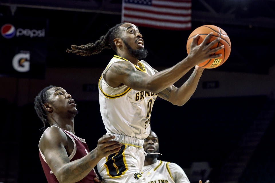 Grambling State guard Shawndarius Cowart (10) puts up a shot as Texas Southern forward Joirdon Karl Nicholas (5) defends during the first half of an NCAA college basketball game in the championship of the Southwestern Athletic Conference Tournament, Saturday, March 11, 2023, in Birmingham, Ala. (AP Photo/Butch Dill)