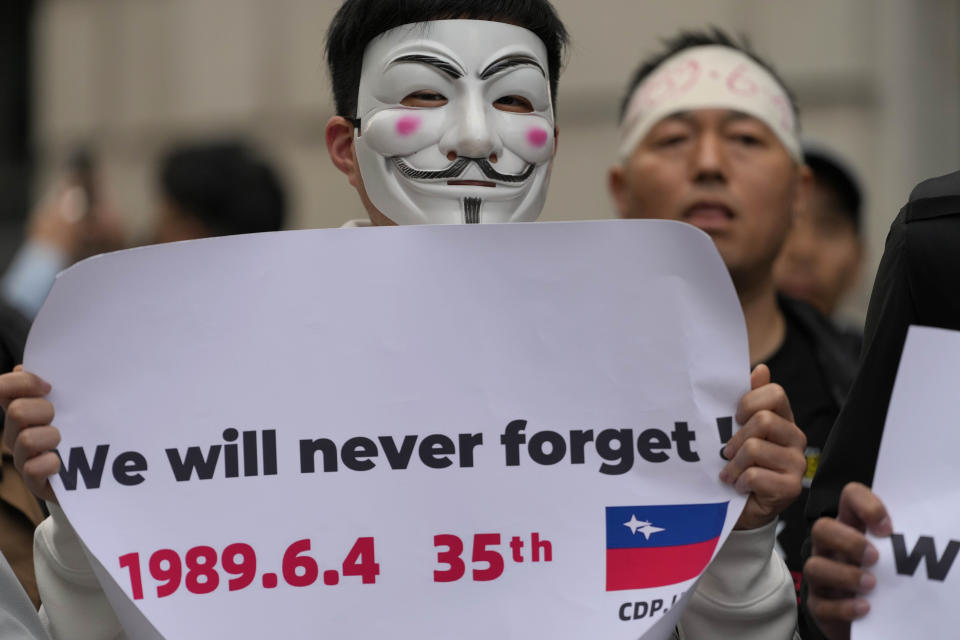 A Demonstrator holds a placard as protesters gather for a Candlelight vigil to commemorate the 35th anniversary of the 1989 pro-democracy movement and China's Tiananmen Square crackdown approaches at the Chinese embassy in London, Tuesday, June 4, 2024.(AP Photo/Kirsty Wigglesworth)