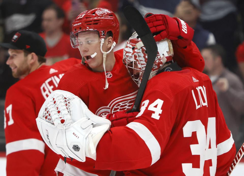 Detroit Red Wings goaltender Alex Lyon (34) is congratulated by left wing Lucas Raymond, left, after the Red Wings 8-3 win over the Washington Capitals in an NHL hockey game Tuesday, Feb. 27, 2024, in Detroit. (AP Photo/Duane Burleson)
