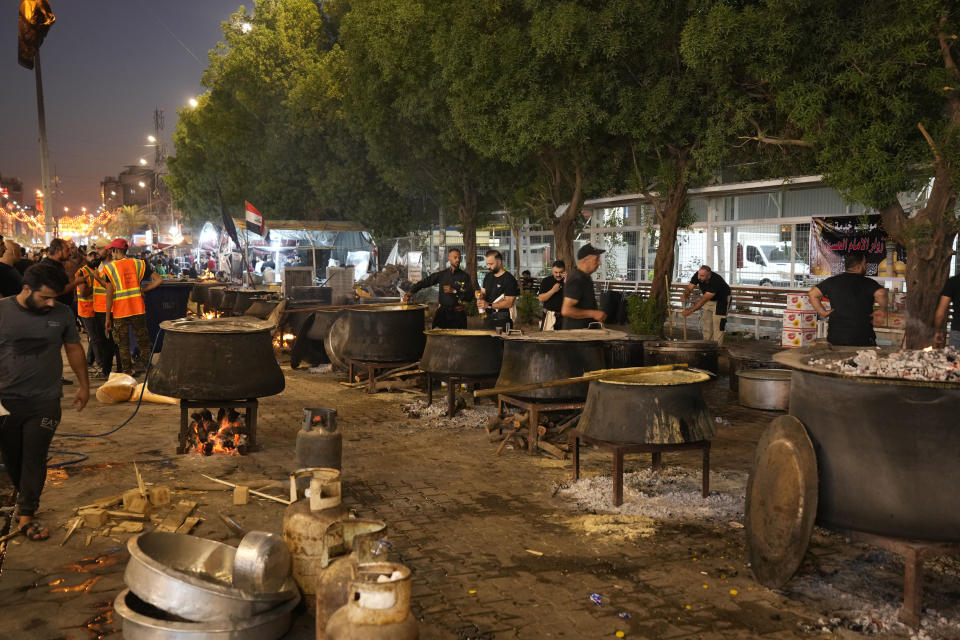 Devotees prepare food for Shiite Muslims on the 9th day of Muharram, outside the golden-domed shrine of Imam Moussa al-Kadhim in Baghdad, Iraq, Friday, July 28, 2023. During Muharram, Islam's second holiest month, Shiites mark the death of Hussein, the grandson of the Prophet Muhammad, at the Battle of Karbala in present-day Iraq in the 7th century. (AP Photo/Hadi Mizban)