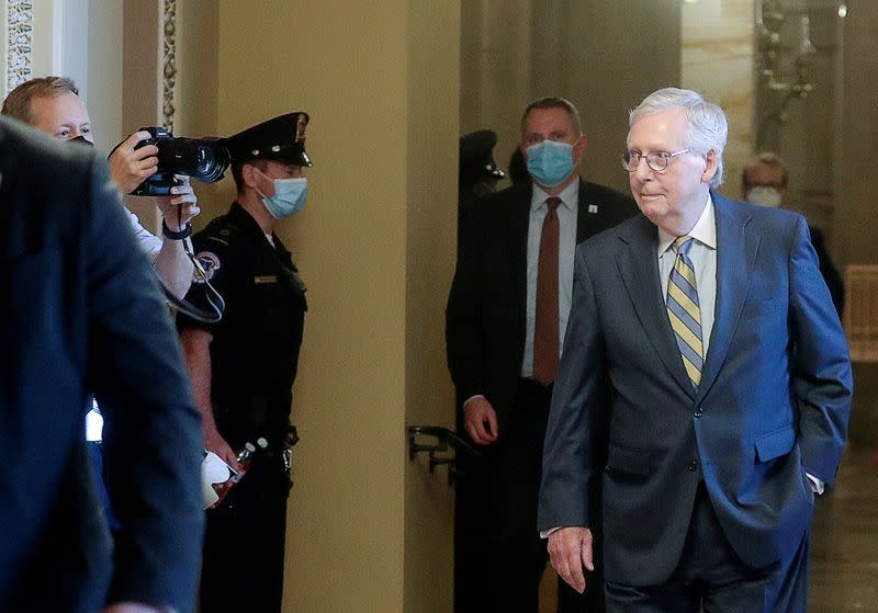 U.S. Senate Republican Leader Mitch McConnell walks through Ohio Clock Corridor prior to delayed debt limit vote at the U.S. Capitol in Washington