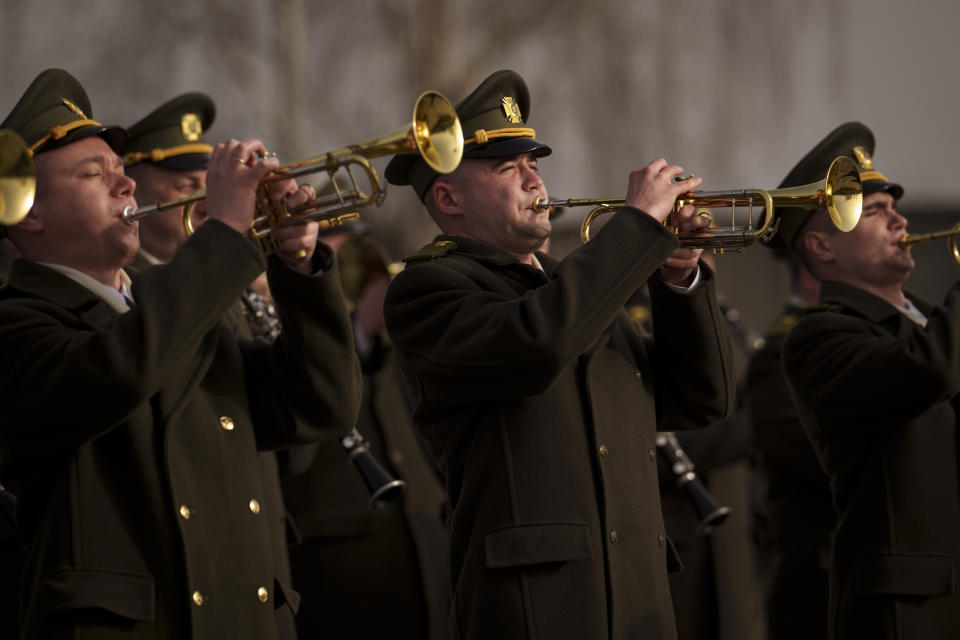 A military band plays during a commemoration for the victims of the Russian occupation at a cemetery in Bucha, Ukraine, Sunday, March 31, 2024. Ukrainians mark the second anniversary of the liberation of Bucha, during which Russian occupation left hundreds of civilians dead in the streets and in mass graves in Bucha during the initial months of the Russian invasion in 2022. (AP Photo/Vadim Ghirda)