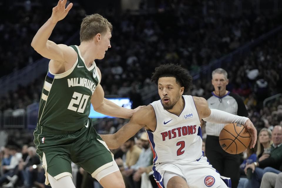 Detroit Pistons' Cade Cunningham tries to get past Milwaukee Bucks' AJ Green during the second half of an NBA basketball game Saturday, Dec. 16, 2023, in Milwaukee. (AP Photo/Morry Gash)