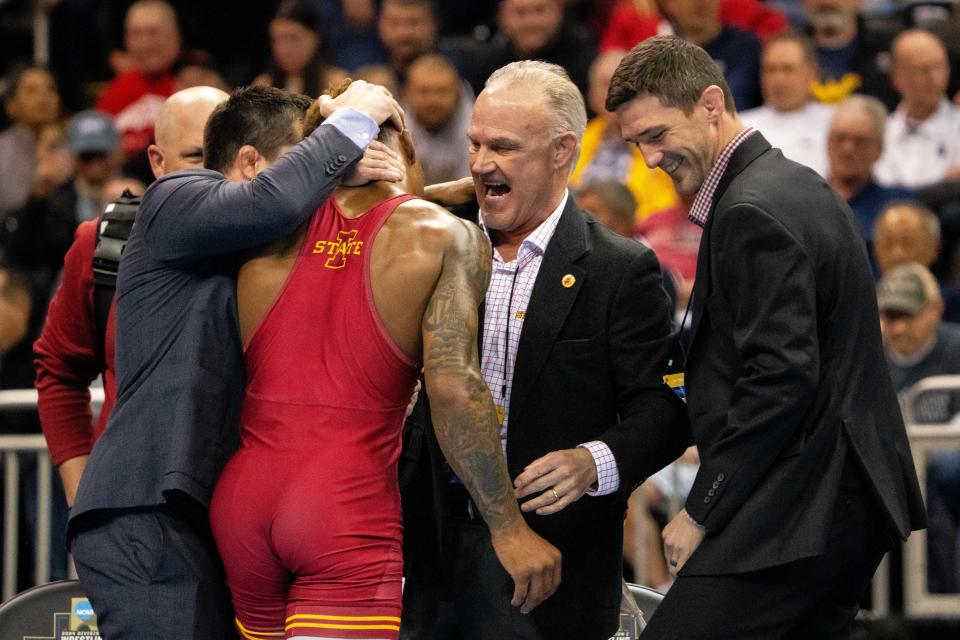 Iowa State's David Carr celebrates his NCAA championship with coach Kevin Dresser on Saturday at the T-Mobile Center in Kansas City.