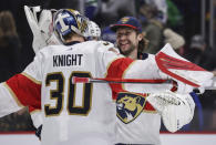 Florida Panthers goalie Spencer Knight, left, and goalie Sergei Bobrovsky celebrate after the Panthers defeated the Vancouver Canucks in an NHL hockey game Friday, Jan. 21, 2022, in Vancouver, British Columbia. (Darryl Dyck/The Canadian Press via AP)