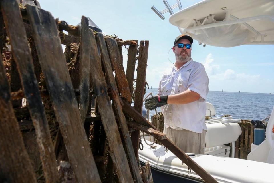 Capt. Spencer Crowley docks at Matheson Hammock Park & Marina on a boat loaded with abandon crab and lobster traps during the Ghost Trap Rodeo event in Coral Gables, Florida, Sunday, July 16, 2023.