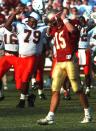 FILE - In this Nov. 16, 1991, file photo, Miami's Jesse Mitchell (79) exults as dejected Florida State kicker Gerry Thomas (15) walks off the field after missing a field goal that would have won the game for FSU in Tallahassee, Fla. The game was the first 1-2 matchup between two teams in the same state since Purdue and Notre Dame did in 1968, and it marked a shift in the landscape of college football to the Sunshine State. (AP Photo/Don Dughi, File)