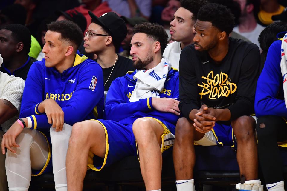 Warriors guard Klay Thompson, middle, and teammates watch as the Lakers rout Golden State during Game 3 of their Western Conference semifinal at Crypto.com Arena in Los Angeles.