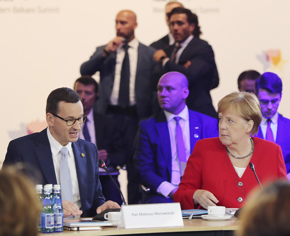 German Chancellor Angela Merkel,right, and Poland's Prime Minister Mateusz Morawiecki listening to a speech by Poland's President Andrzej Duda during a summit meeting that aims to reassure Western Balkan states that their aspirations to join the European Union have backing among EU leaders, in Poznan, Poland, Friday, July 5, 2019.(AP Photo/Czarek Sokolowski)