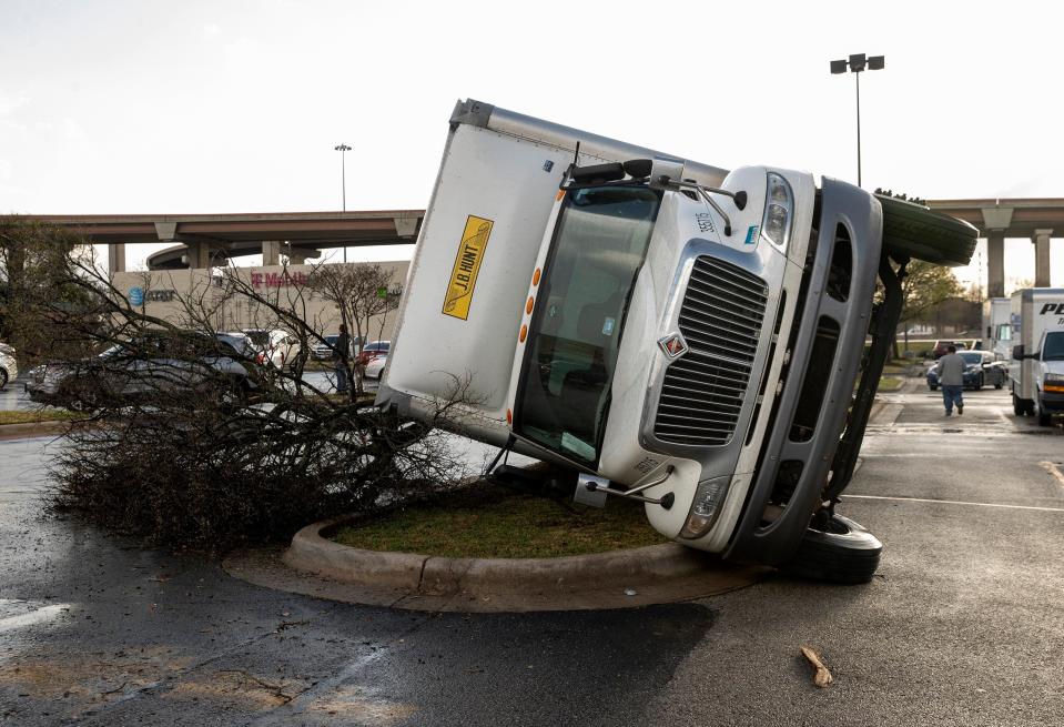 A truck is knocked on its side after a tornado hit a shopping center near I-35 and SH 45 in Round Rock, Texas (AP)