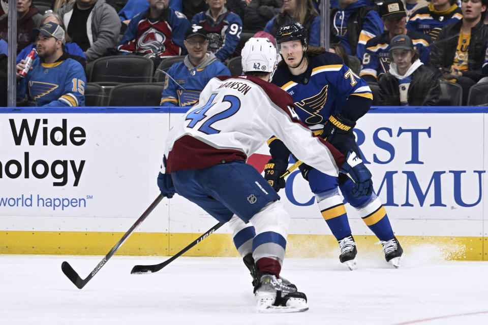 St. Louis Blues' Sundqvist (70) works the puck against Colorado Avalanche's Josh Manson (42) during the second period of an NHL hockey game Wednesday, Dec. 29, 2023, in St. Louis. (AP Photo/Michael Thomas)